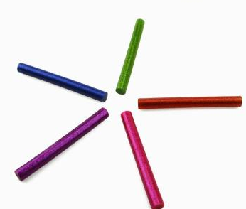 DIY handcrafted creative hot melt glue sticks with colorful gold powder in plastic bags