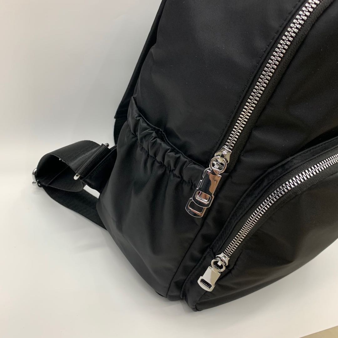 A pair of black women's washed nylon large-capacity backpacks for casual wear details Picture