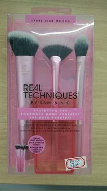 A loose makeup brush, a blush brush, and a highlighter eye brush