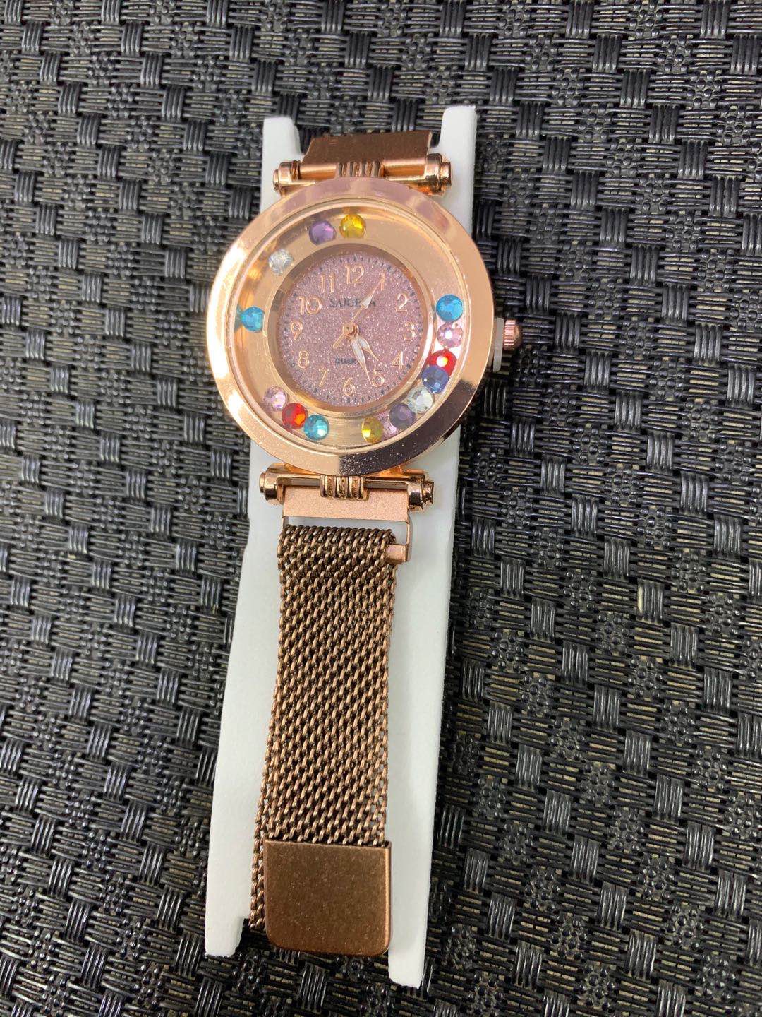 A fashionable ultra-thin ladies' watch with a colored sand and rhinestone strap