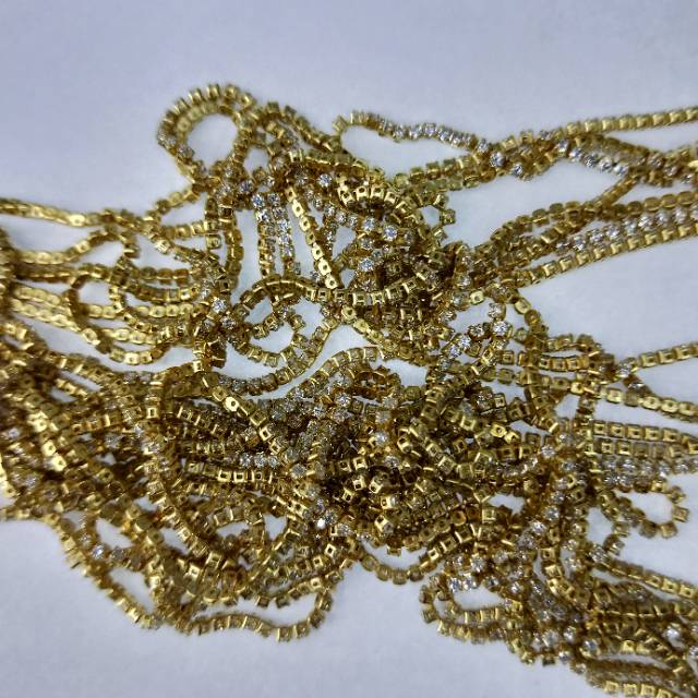 Delicate zircon chain resting on collarbone with natural shadow play