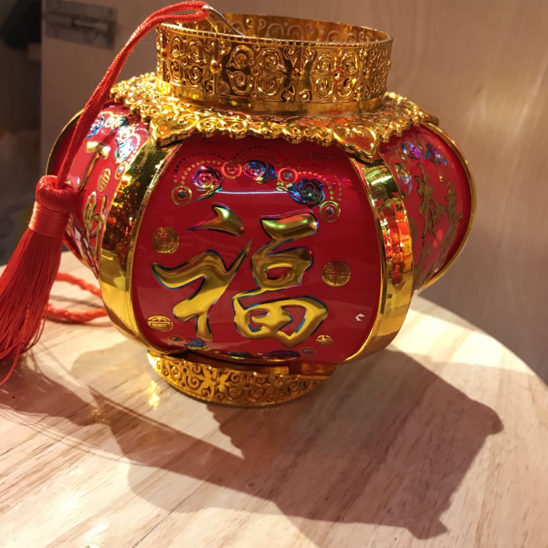 The small palace lantern features a golden and red color scheme with the character "Fu" printed on its surface in a Chinese style Specification image