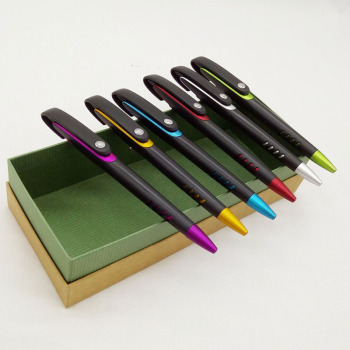 Sandblasted black ballpoint pen with colorful clip on white background