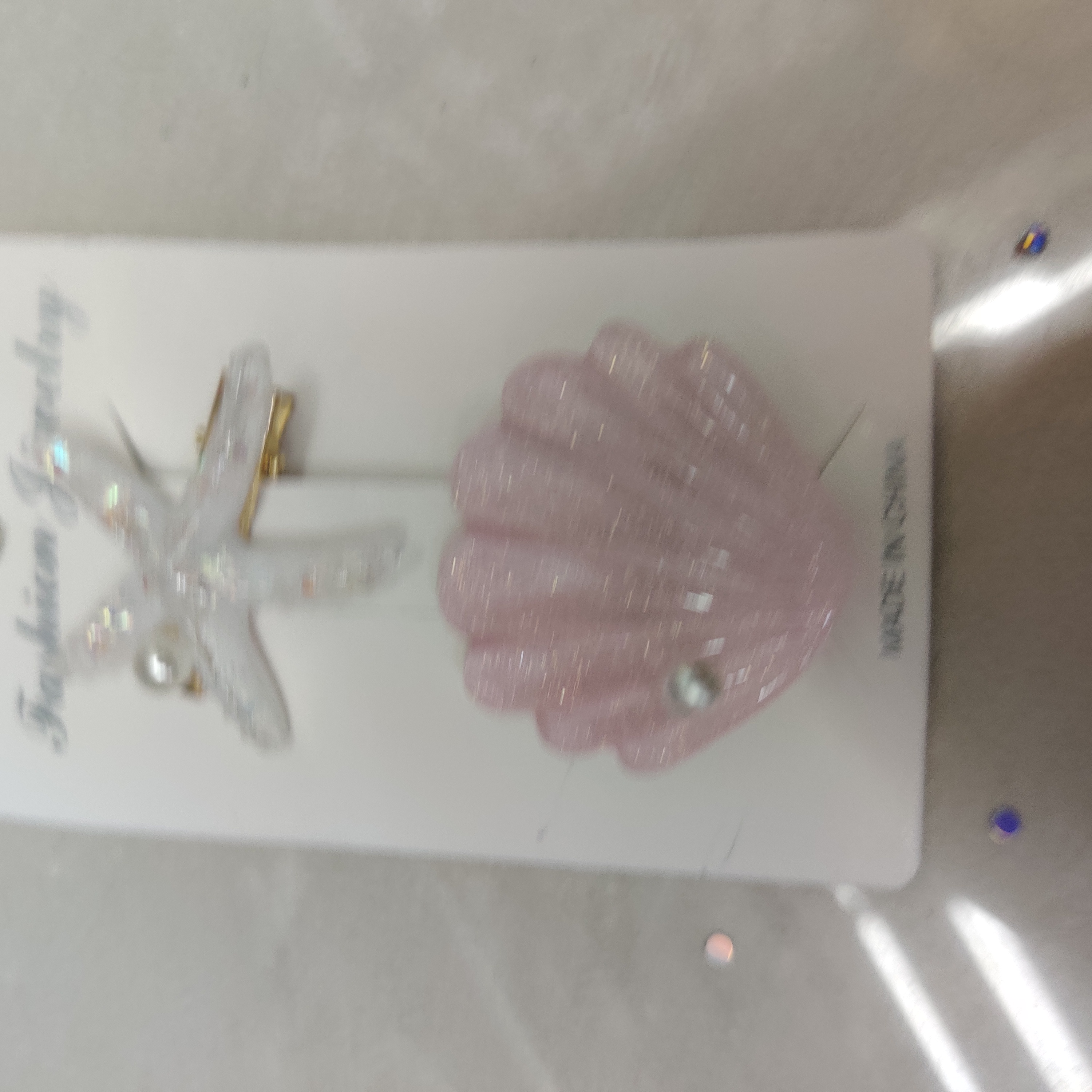 Close-up of retro ocean-themed hair clips with pearls and shells