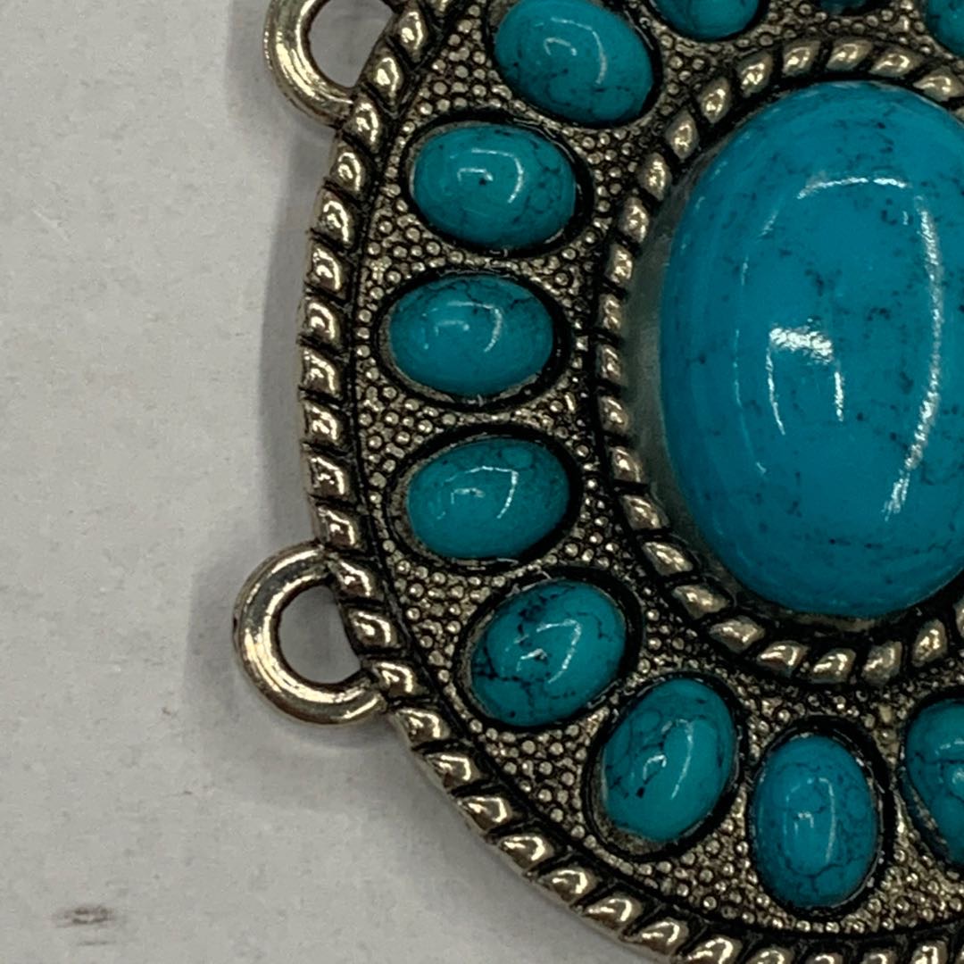 Close-up of detailed vintage belt buckle with ethnic engraving