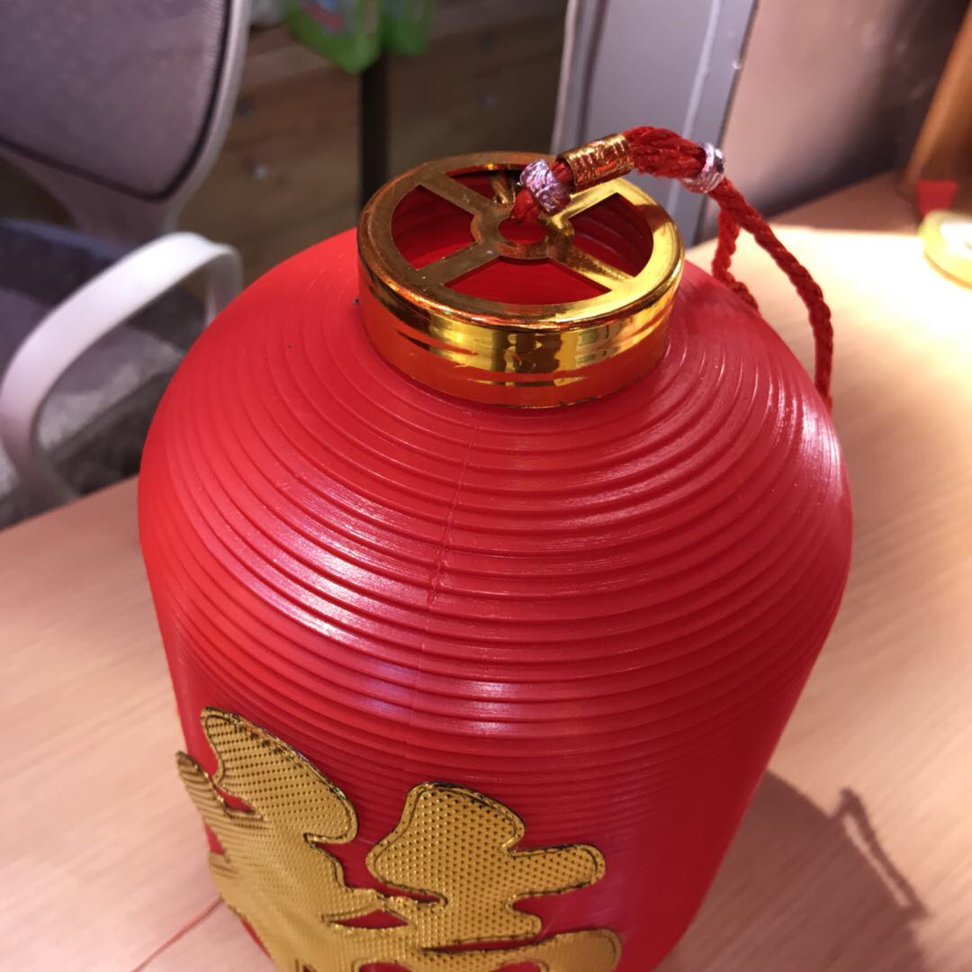 The oval golden "Fu" character stickers on the hand-held lanterns add to the festive atmosphere details Picture