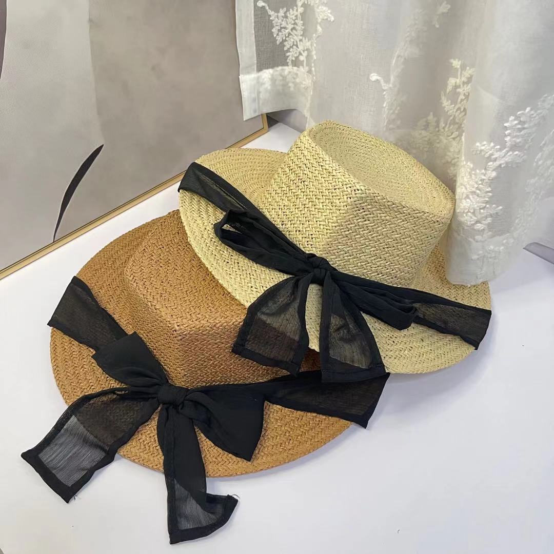 A female hat with a spring and summer ribbon, butterfly sash, hexagonal straw hat, Korean street style, anti-ultraviolet sun hat, and a wide-brimmed hat details Picture