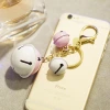 Wholesale of creative and personalized jelly-colored bell keychains, car pendants, claw machine dolls, and women's bag pendants details Picture