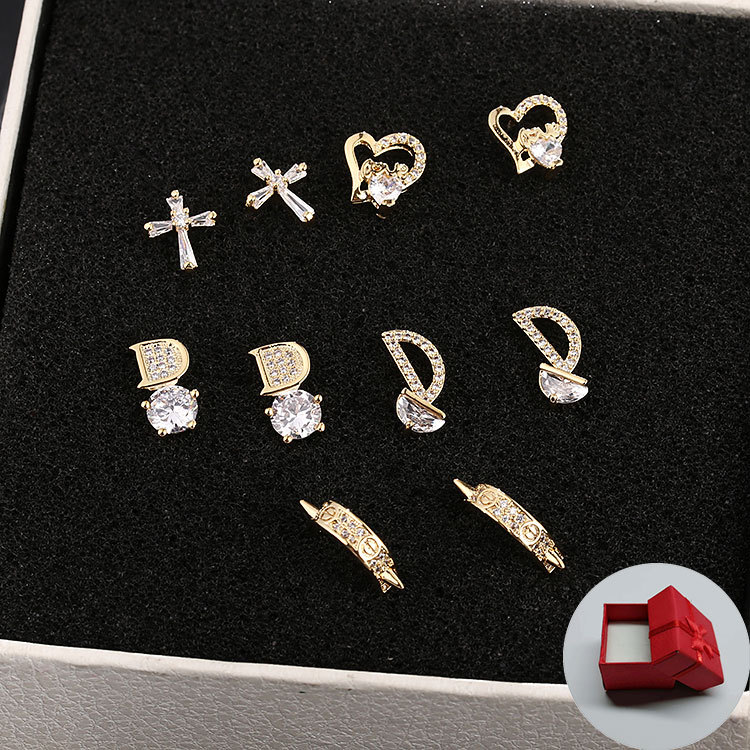 The s925 silver earrings from Japan and South Korea are a versatile and fashionable choice for women. They feature a cross heart letter with zircon stud earrings