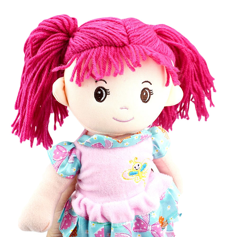 A cute girl in a double-layered floral dress in blue, pink and purple, with a doll as a toy gift, is crossing the border details Picture