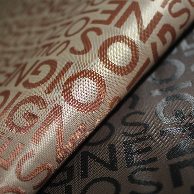 Factory direct sales of cosmetic bag fabric jacquard large letter foamed jacquard foamed chemical fiber polyester fabric in stock supply Specification image