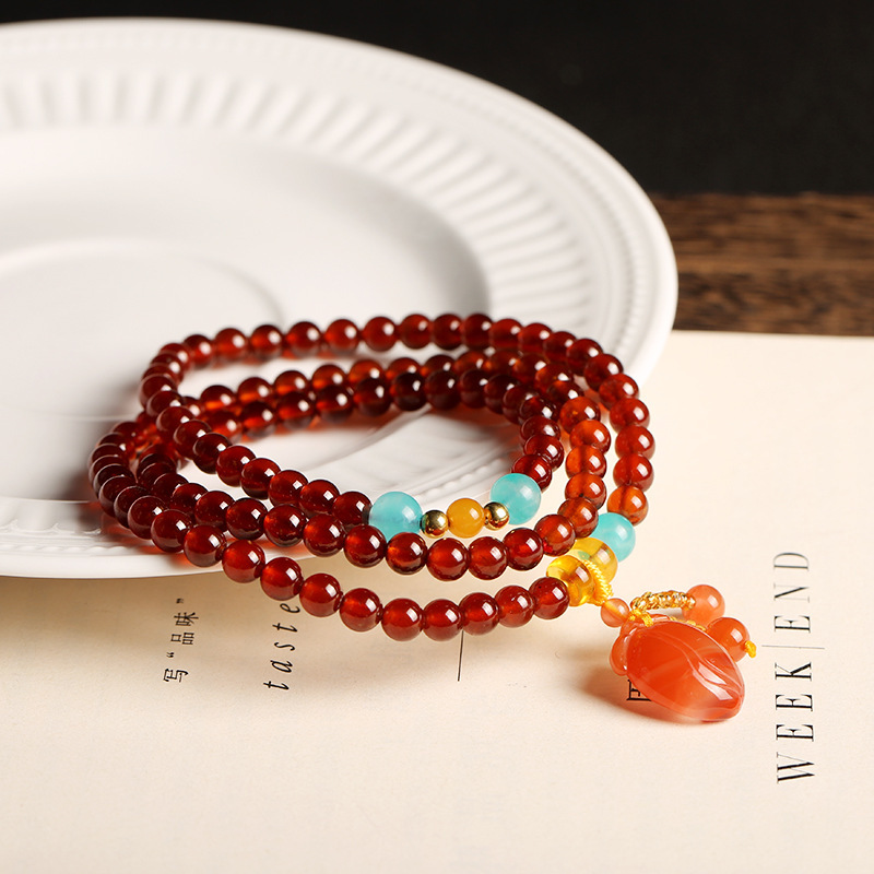 Natural orange-red garnet bracelet with three loops of 5.5mm round beads, paired with a DIY beeswax south red bracelet