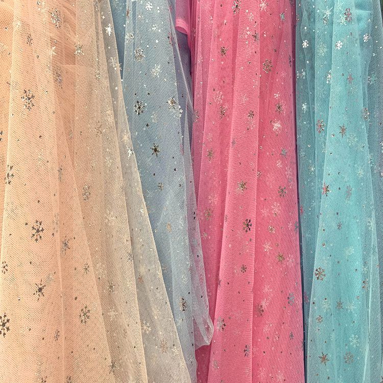 Knitted mesh fabric for clothing, headwear, hair accessories, puffy skirts, toy fabric, Christmas gifts, silver-embossed snowflake mesh fabric Application Scenario