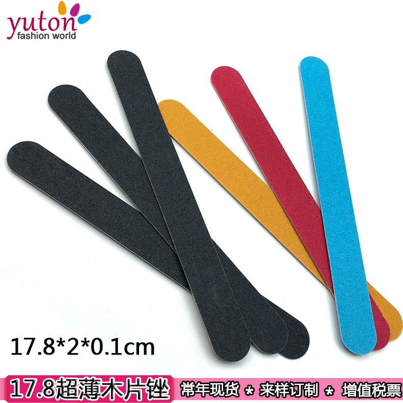 nail file in stock: Thin black sandpaper strips, brown wood chips, nail surface polishing tools, nail files