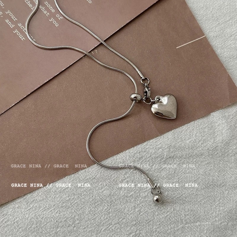 Minimalist silver heart-shaped pendant necklace for women, a light luxury and high-end style titanium steel pull-out long sweater chain accessory Application Scenario