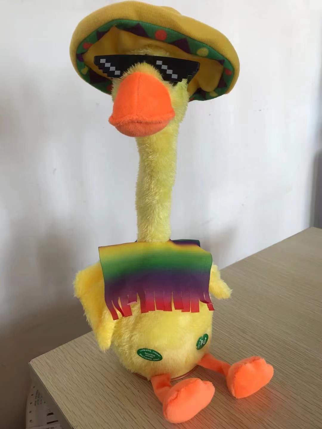 The little yellow duck can dance and twist. It can sing, record and learn to speak. The cactus is enchanting. The music is a plush toy doll Item Picture