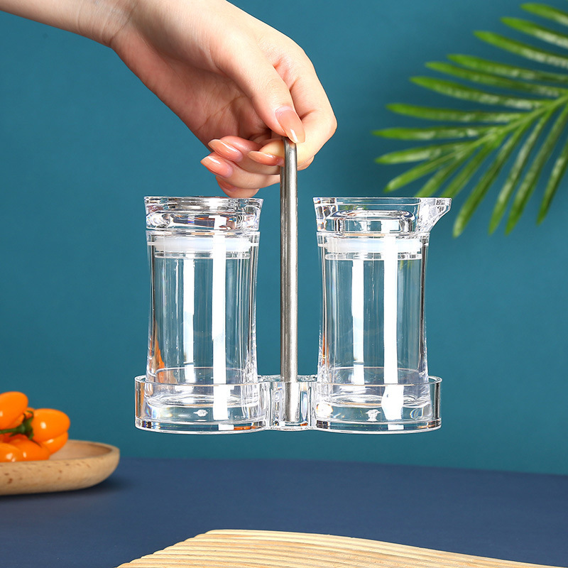 Modern Kitchen Setup Featuring Acrylic Seasoning Bottles and Stainless Steel Tools