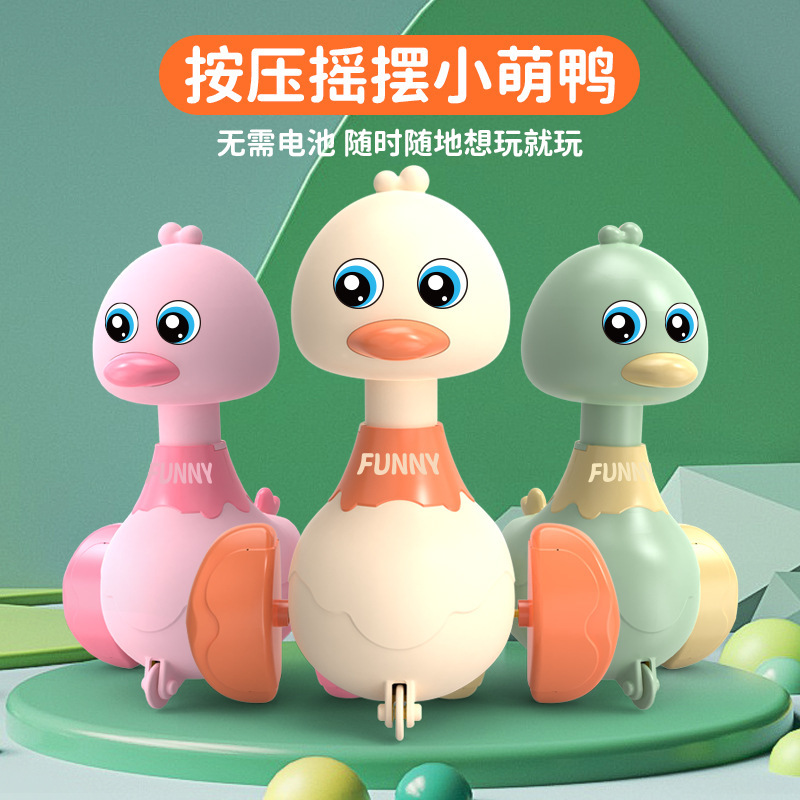 In Chenghai, toy stalls are selling hot and popular products. Wholesale of children's press toy cars with ducklings. A three-year-old boy is going cross-border details Picture
