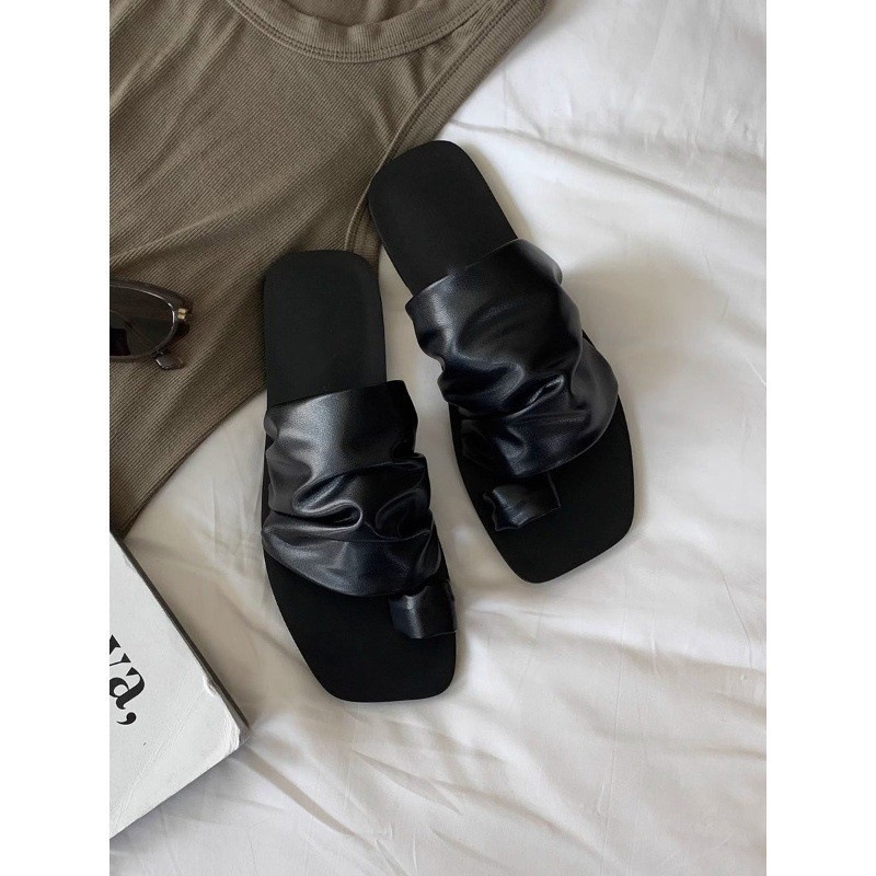 The new design of the flip-flops with a square head, pleats and a flat bottom with a pair of flip-flops for women to wear outside in summer