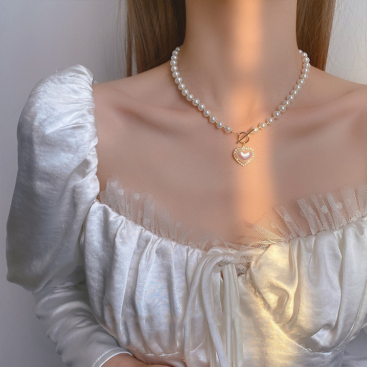 Japanese and Korean pearl heart-shaped necklace, women's real gold color retention electroplating, trendy and niche design sense, elegant collarbone chain, versatile neck chain details Picture