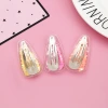 Japanese and Korean creative transparent PVC sequined flowing sand hair clips, candy-colored clips, children's hair accessories and accessories wholesale, children's flowing sand hair clips Application Scenario