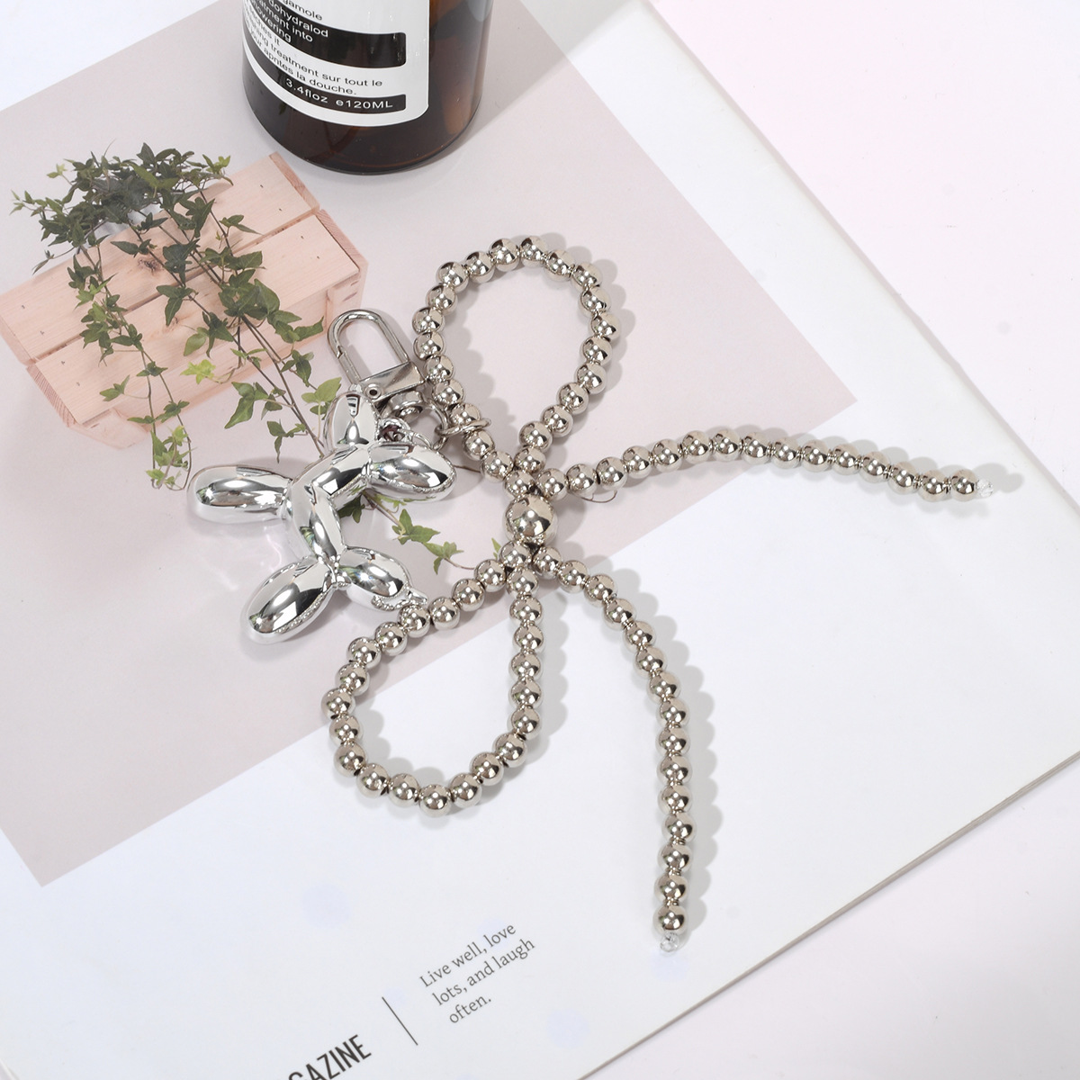 Simple pearl bow, balloon dog, niche design pendant, keychain, bag pendant, wholesale from the source details Picture