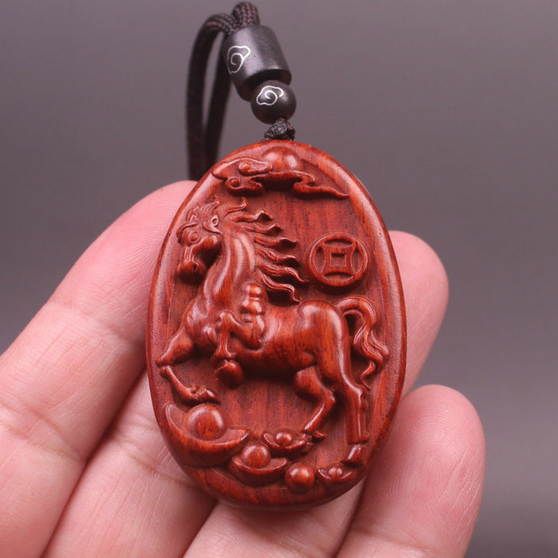 A cute red horse pendant necklace made of rosewood, featuring twelve zodiac animal carvings, and long sweater chains for both men and women