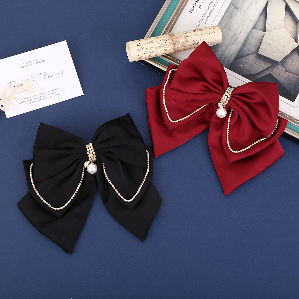 The new elegant satin pearl bow hair clip is simple and stylish. It is a high-end and versatile top clip for engagement banquets
