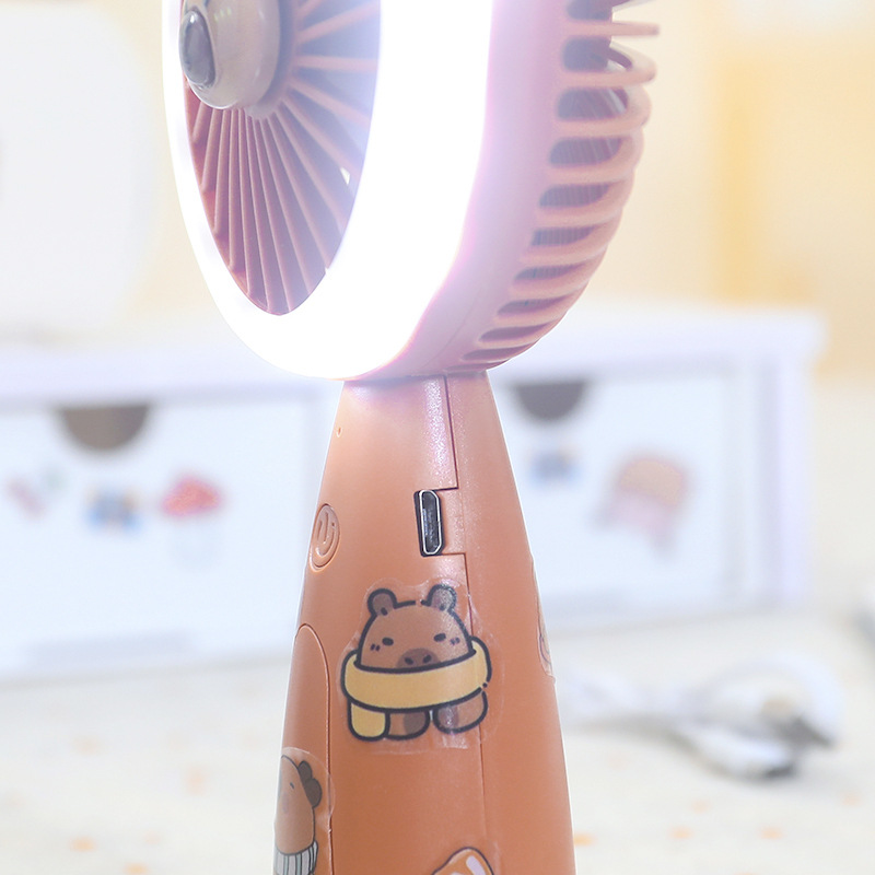 New three-speed strong wind power cartoon sticker handheld fan, student portable charging LED light desktop small fan Application Scenario