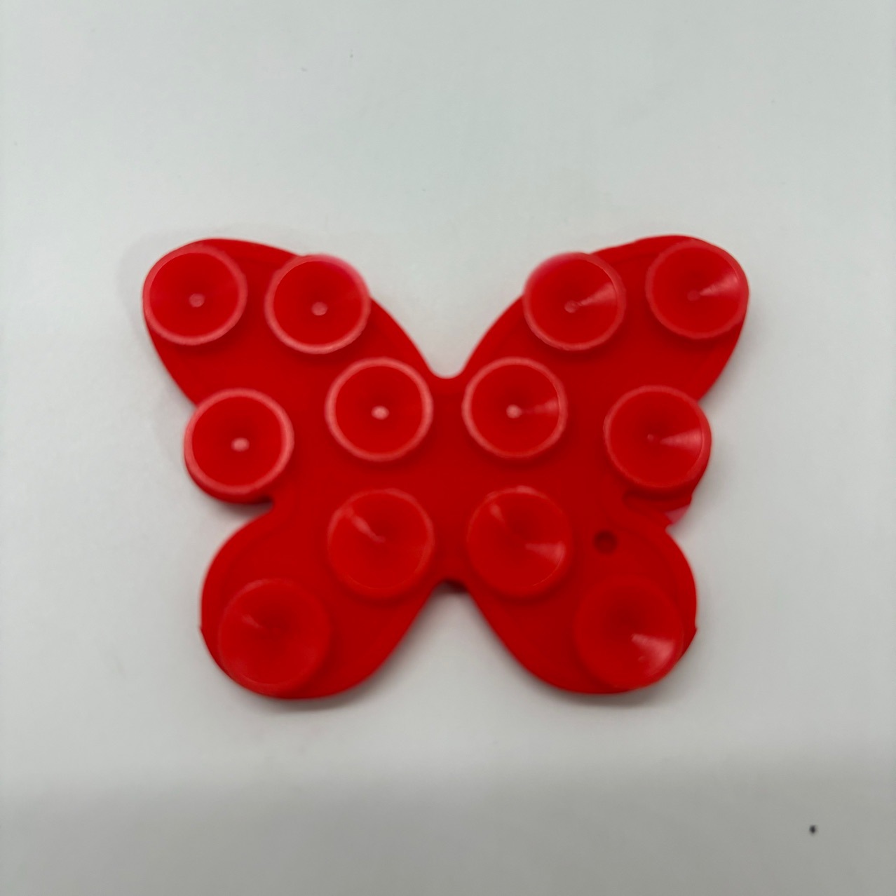 The factory sells multi-functional silicone double-sided adhesive suction cup mobile phone stick butterfly granule self-adhesive mobile phone bracket Application Scenario