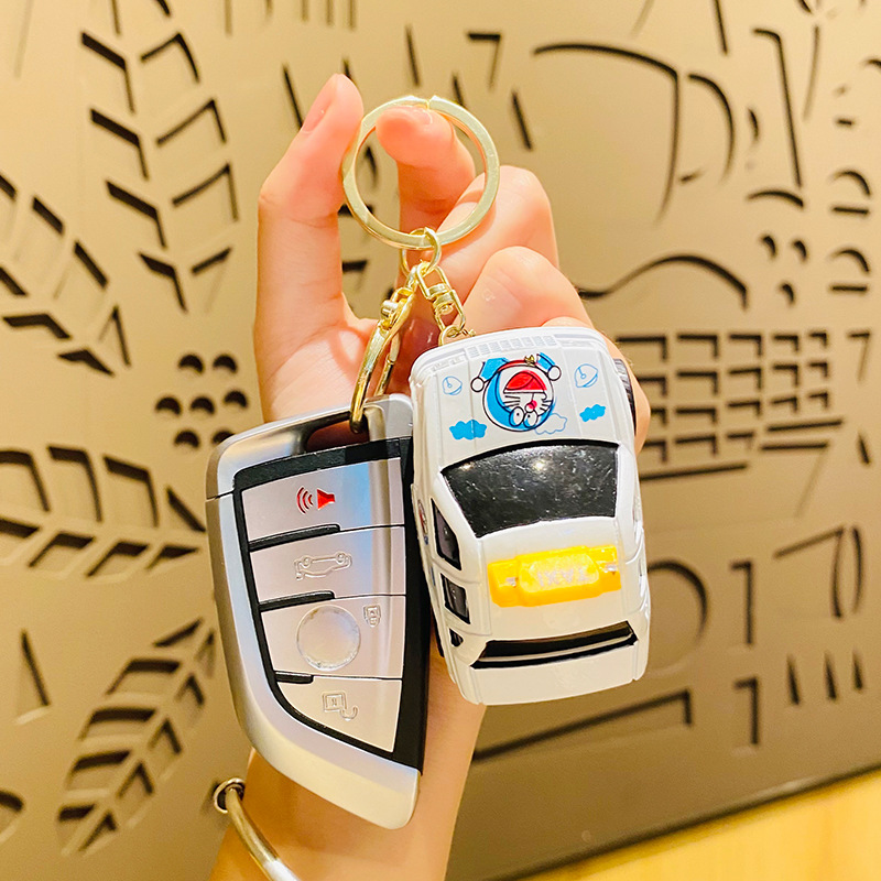 Wholesale of cartoon cute Doraemon toy cars, creative keychains, student schoolbags, pendants and couple small gifts details Picture