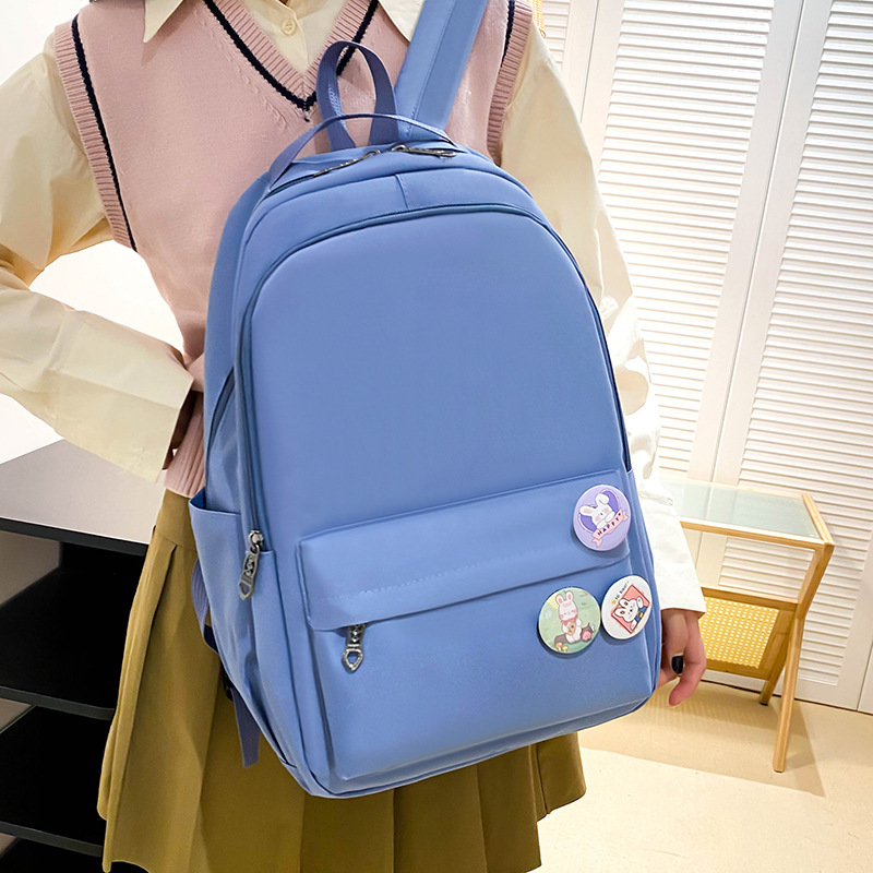The 2024 new solid-color Korean-style simple backpack has a high appearance level and large capacity shoulder protection. It is a backpack that reduces the burden on college students