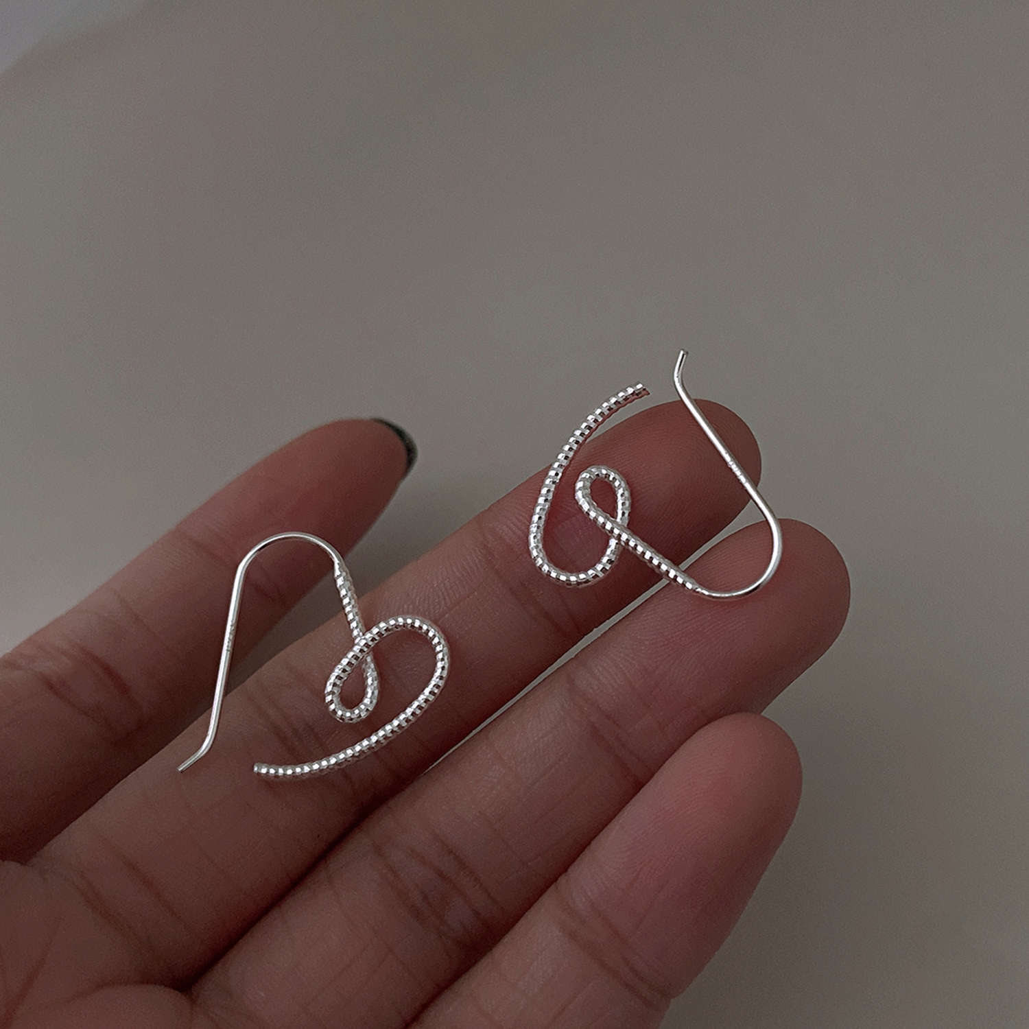 The new 2021 style of the "Twisted heart-shaped opening welded heart-shaped stud earrings" with a minimalist design and a cool style for women