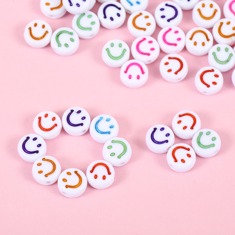 A 100-piece package of acrylic flat round white background colorful cartoon smiling face beads DIY mobile phone chain small beads Specification image