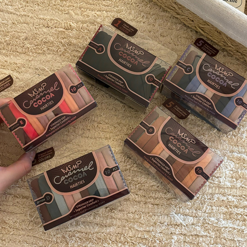 The box-packed coffee-colored high-elasticity towel ring is a basic and practical hair-tying rubber band that is durable and won't damage hair. It is also a hair tie and hair accessory