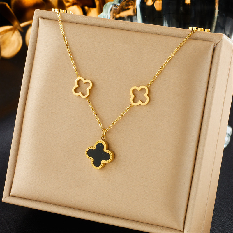 A niche design double-sided four-leaf clover titanium steel necklace with a fashionable and elegant feminine touch, featuring a light luxury hollowed-out flower mother-of-pearl collarbone chain and a personalized accessory