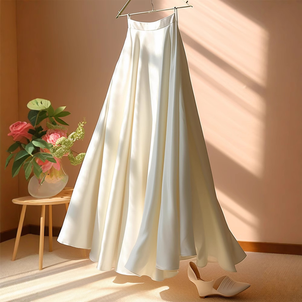 The cool white outfit features a high-waisted, slimming A-line umbrella skirt and a petite, light luxury satin skirt for women in spring