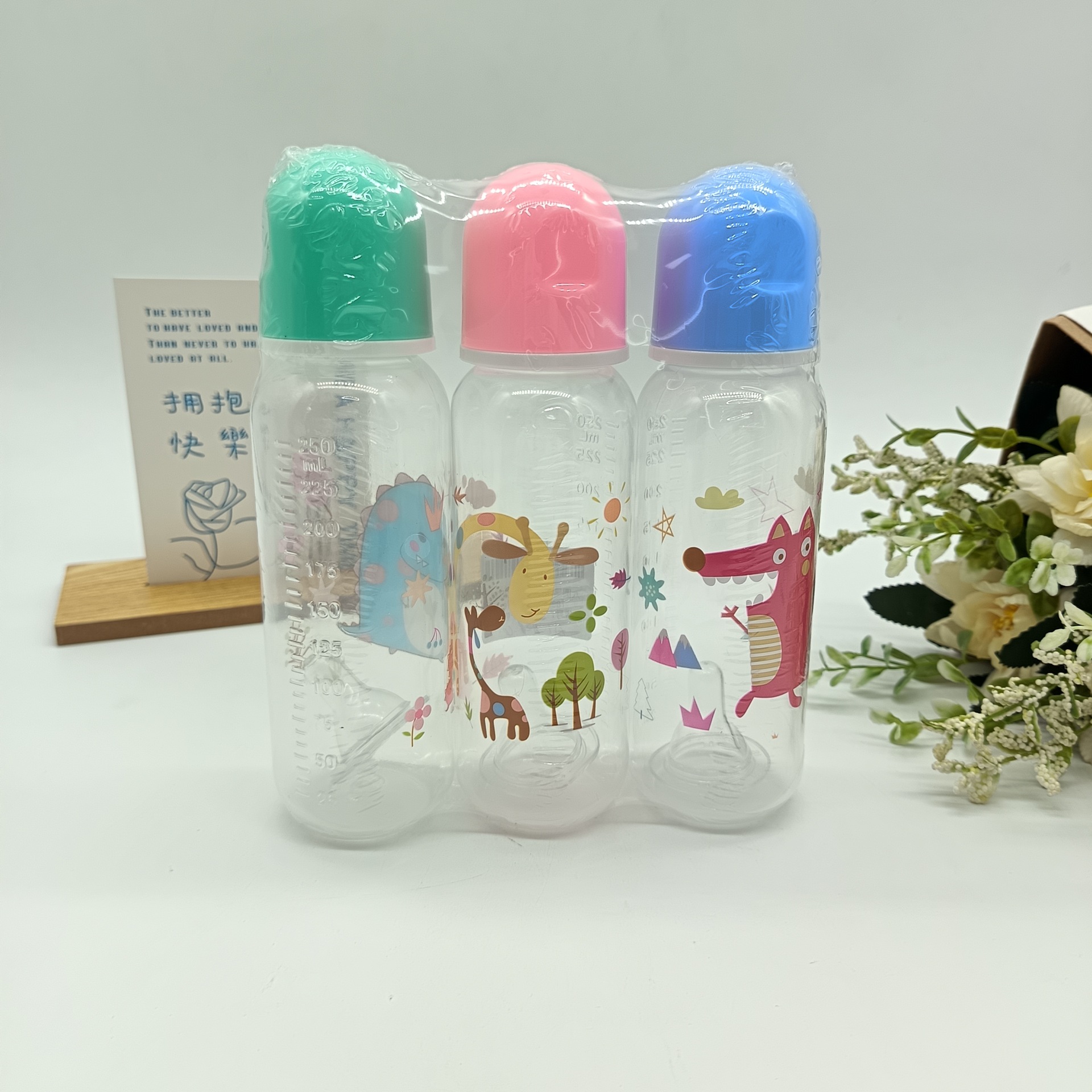 A set of three of the best-selling baby bottles made of pp material with cute and fun patterns for wholesale trade, including silicone pacifiers and cups details Picture