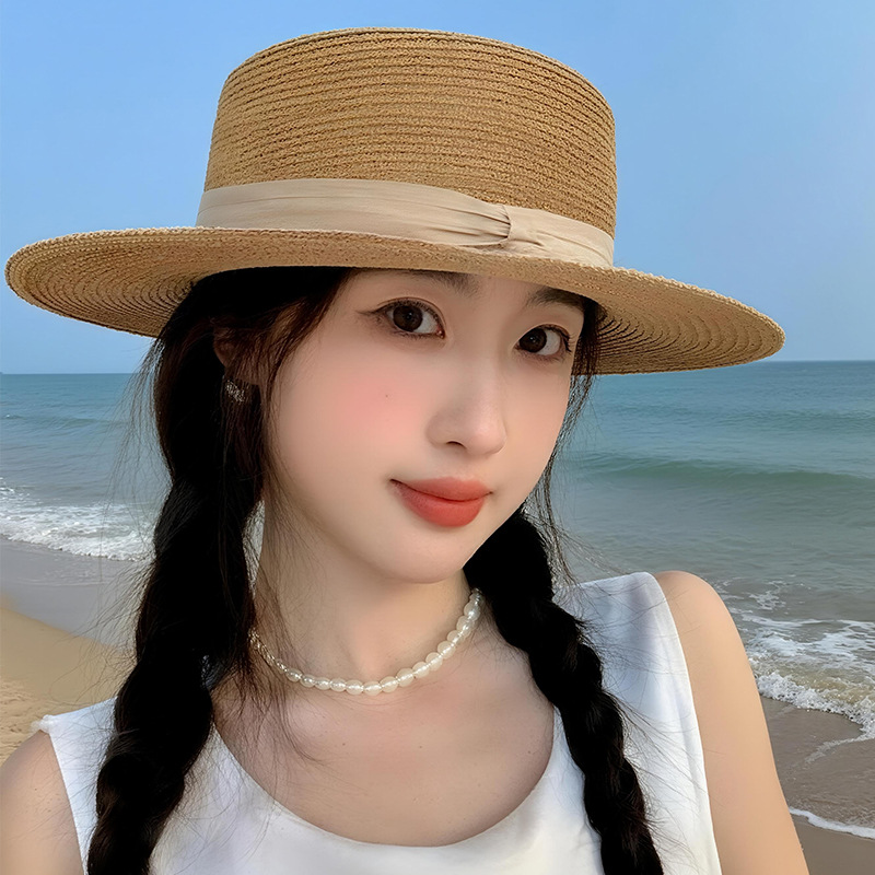 A flat-topped straw hat, a straw woven hat, a women's summer top hat, a wide-brimmed sun-protective hat, a beach hat