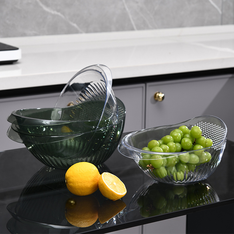 The simple fashion vegetable washing basket is a kitchen household wonder. It features a multi-functional plastic basin, a high-end double-layer fruit plate, and a convenient draining basket Application Scenario