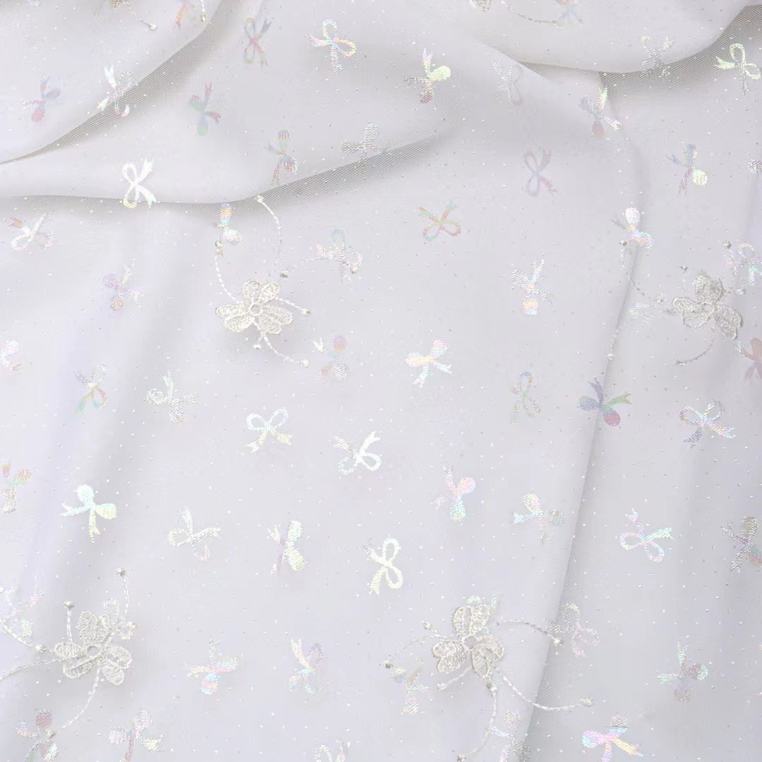 Hongli Technology HLJC-0181, a manufacturer, offers colorful clover embroidery, bow embroidery, mesh fabric, children's clothing embroidery, lace, wedding dress trim fabric. We support rice sample cutting, direct delivery and customization in stock Specification image