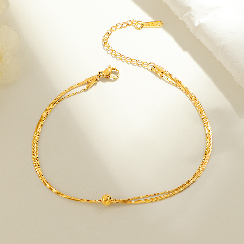 Double-layer snake bone anklets with movable beads, women's titanium steel gold summer new style, versatile and non-fading small gold ball anklets Application Scenario