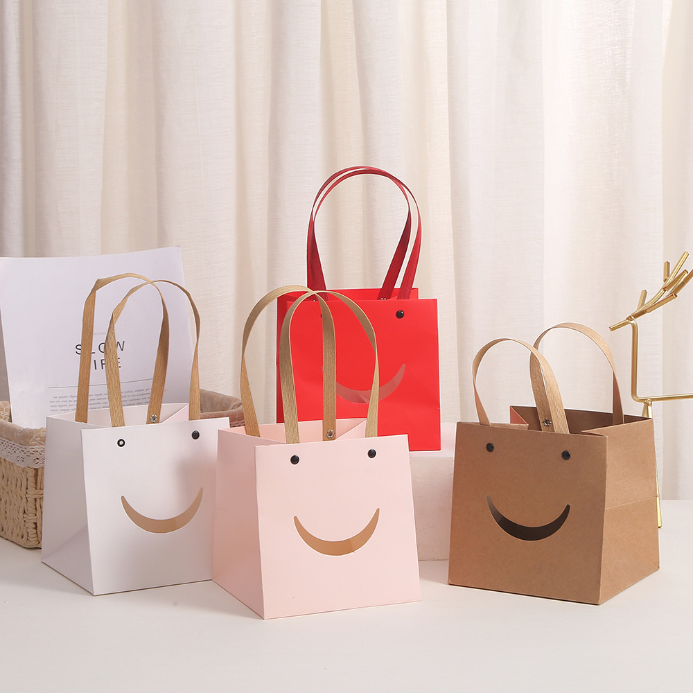 Kraft paper with an open smiling face, creative cartoon kraft paper bag, shopping clothing, kraft paper handbag, gift packaging