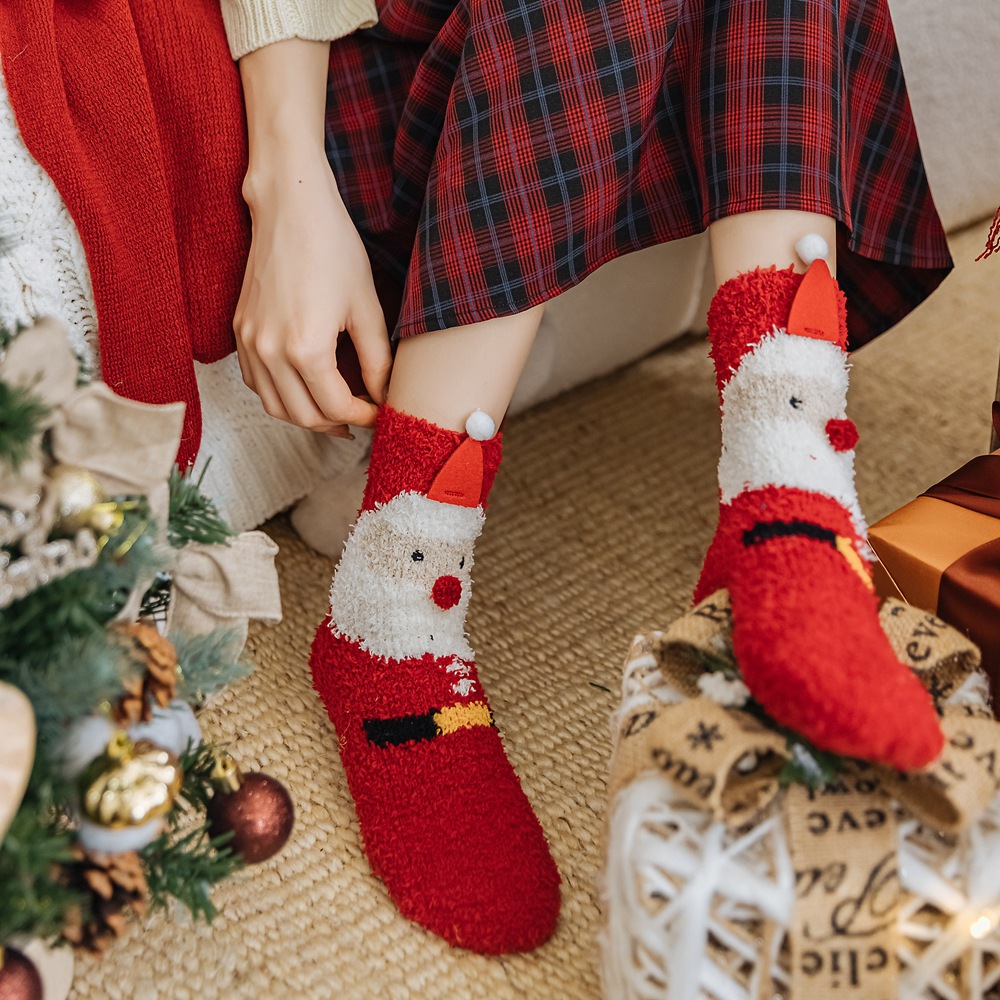 Christmas socks styled with a cozy sweater and blanket