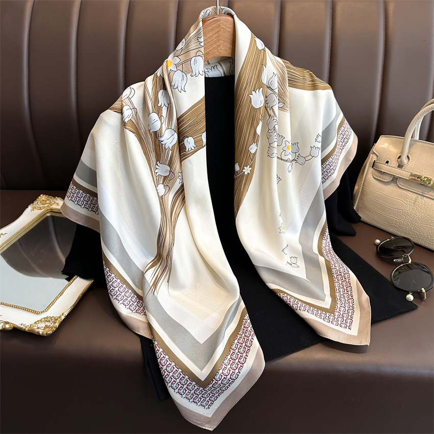 A 90cm new elegant and stylish square scarf with a twill pattern featuring Chinese trend lily of the valley flowers. It is a versatile sun-protective shawl and headscarf for women