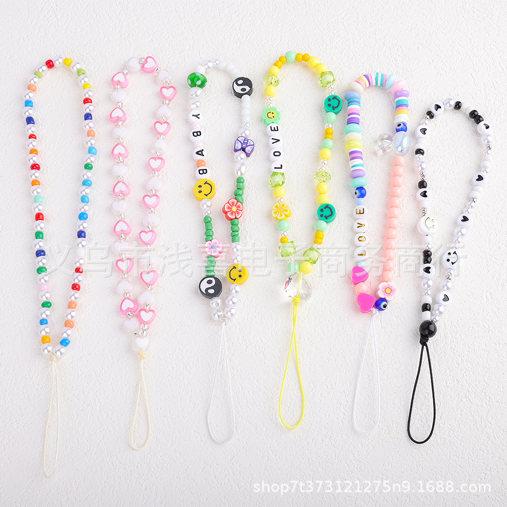 New colored rice bead mobile phone chain from ins in Europe and America, pearl smiling face beaded heart-shaped mobile phone accessory pendant for women