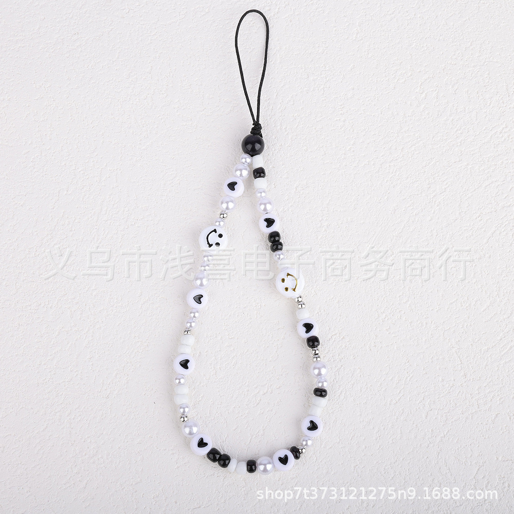 New colored rice bead mobile phone chain from ins in Europe and America, pearl smiling face beaded heart-shaped mobile phone accessory pendant for women Specification image