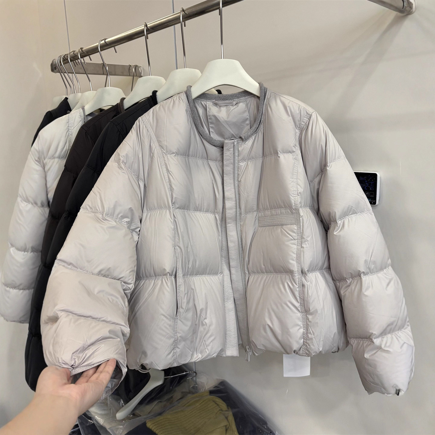 A new thickened and warm white duck down jacket for women in the 2025 winter, featuring a Korean-style rolled-up round-neck light down jacket details Picture