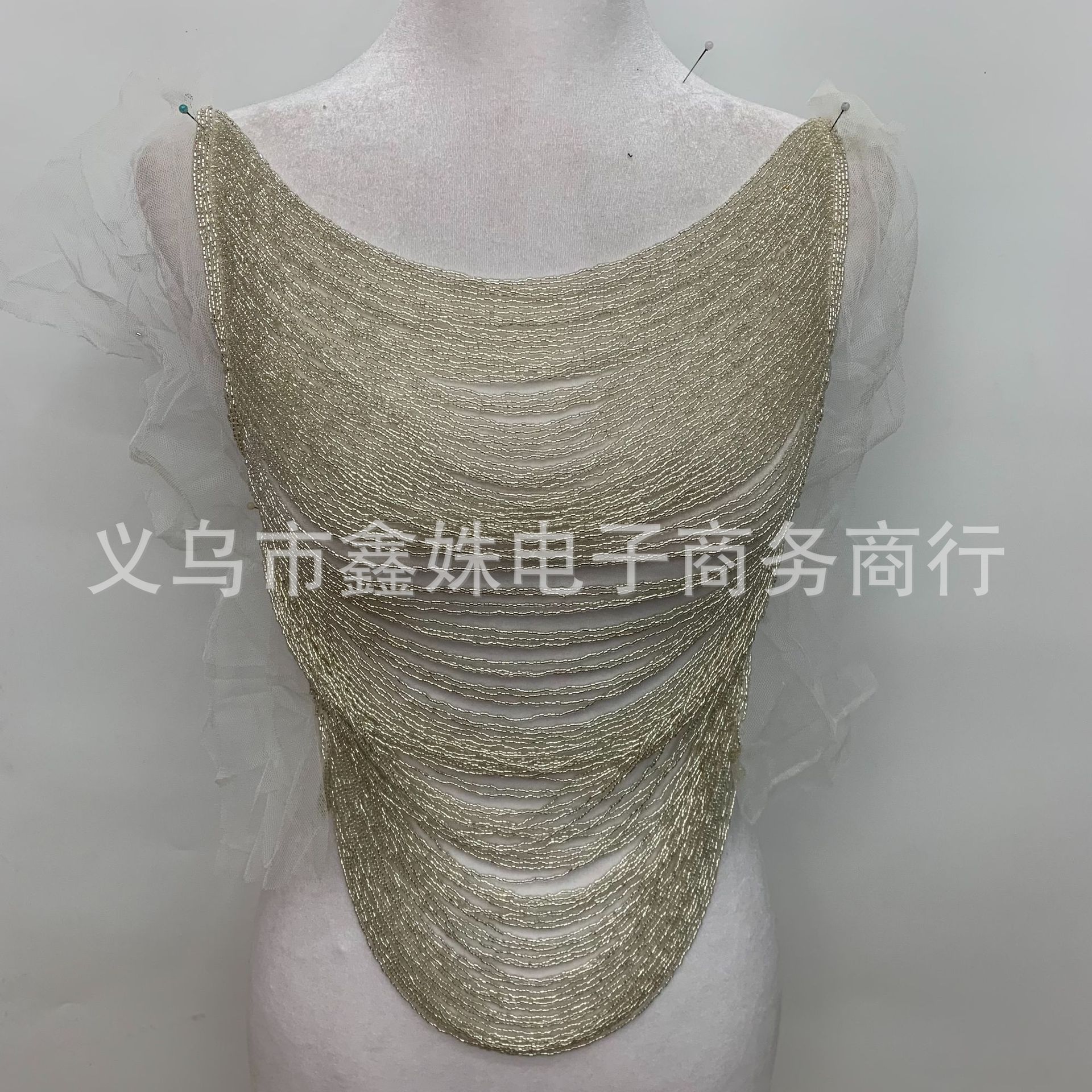 A fashionable, cut-out round-neck sleeveless top with multi-color beaded tassels and floral edges, and sexy clothing accessories