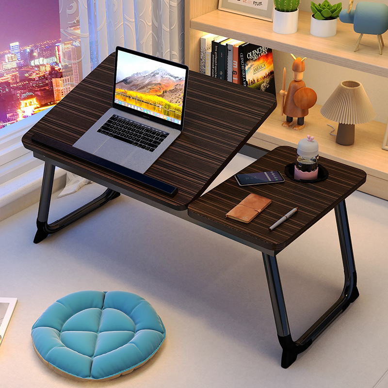 The small computer desk on the bed can be raised, lowered and folded. It is a home student writing desk for the bedroom and a lazy study desk for the dormitory